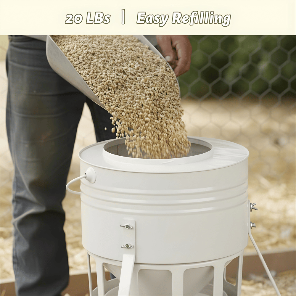 Person refilling a white chicken feeder with grain.