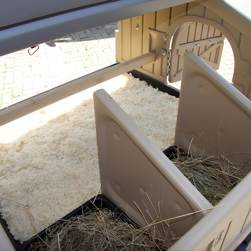 Close-up of a beige plastic chicken coop.